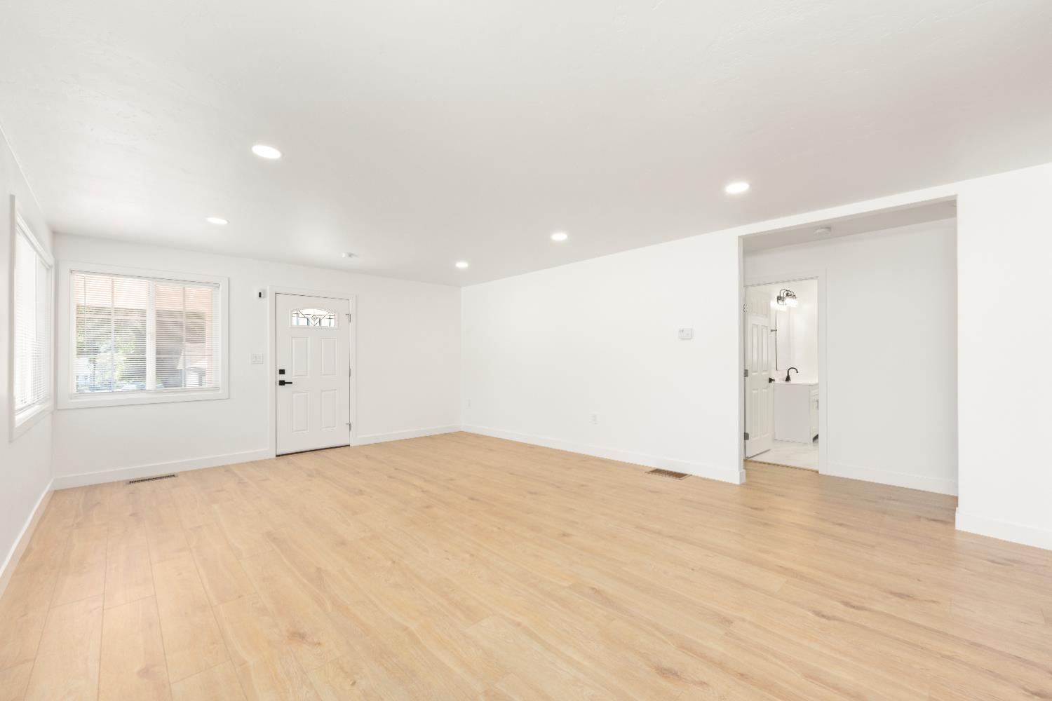 185 Mill Street Sutter Creek, CA 95685 - Photo 24 of 77 a view of an empty room with wooden floor and windows