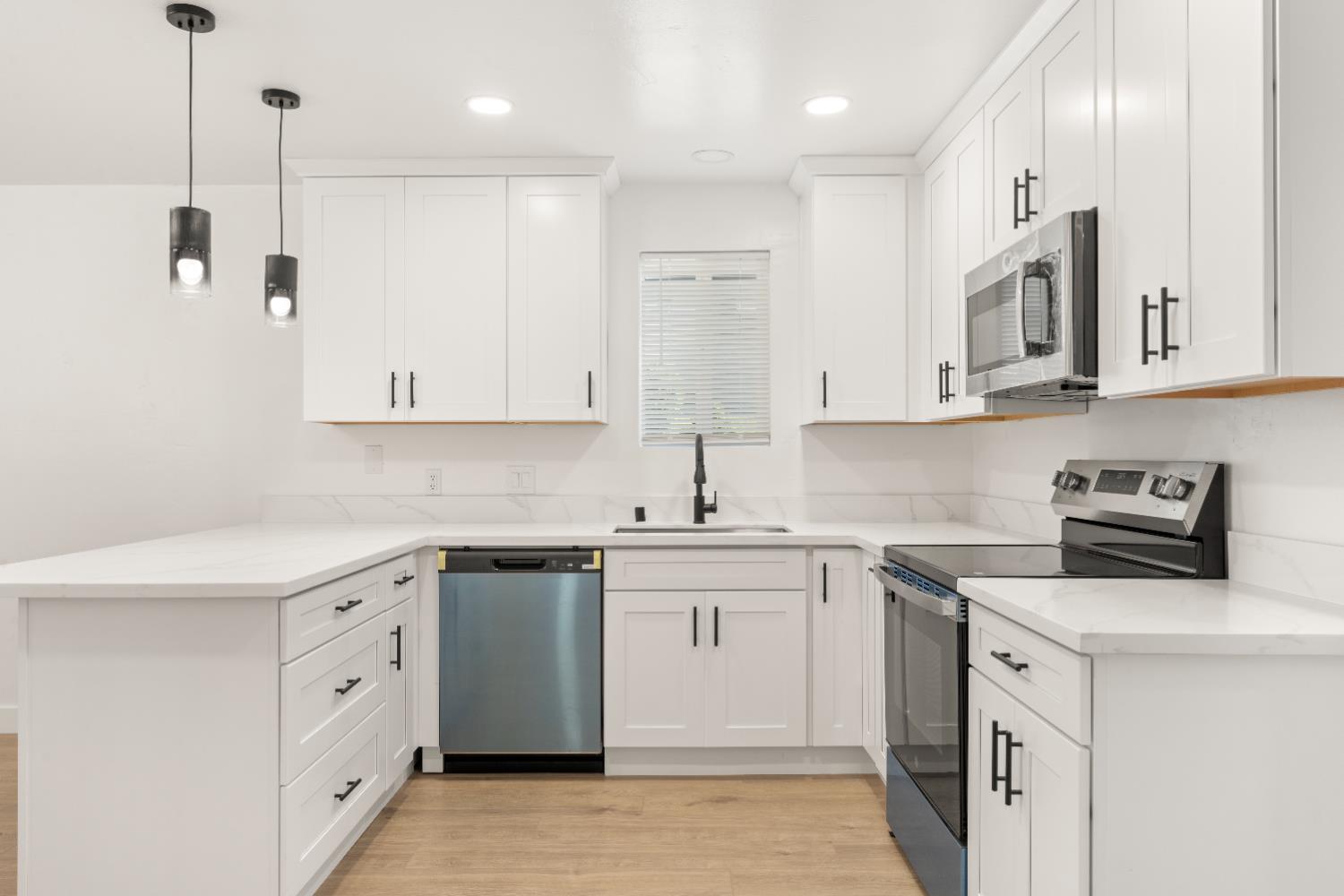 185 Mill Street Sutter Creek, CA 95685 - Photo 28 of 77 a kitchen with white cabinets stainless steel appliances and sink
