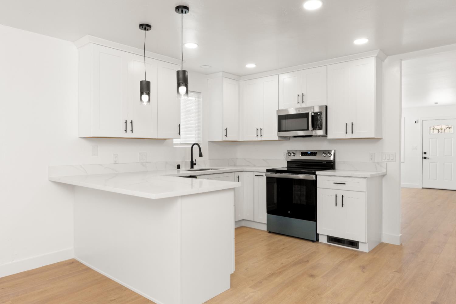 185 Mill Street Sutter Creek, CA 95685 - Photo 31 of 77 a kitchen with stainless steel appliances white cabinets a sink and a stove