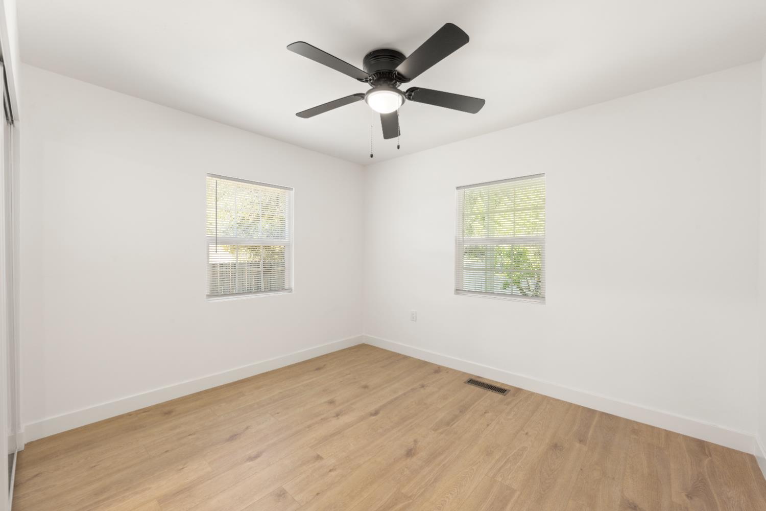 185 Mill Street Sutter Creek, CA 95685 - Photo 48 of 77 an empty room with wooden floor and ceiling fan