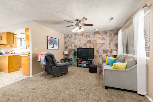 3707 Gates Circle Santa Clara, UT 84765 - Photo 6 of 19 Living area with light carpet, a ceiling fan, a textured ceiling, and light tile patterned floors