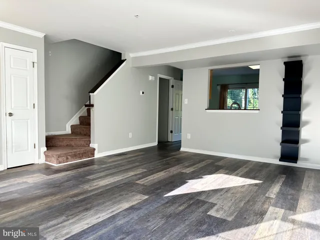 a view of an empty room and wooden floor