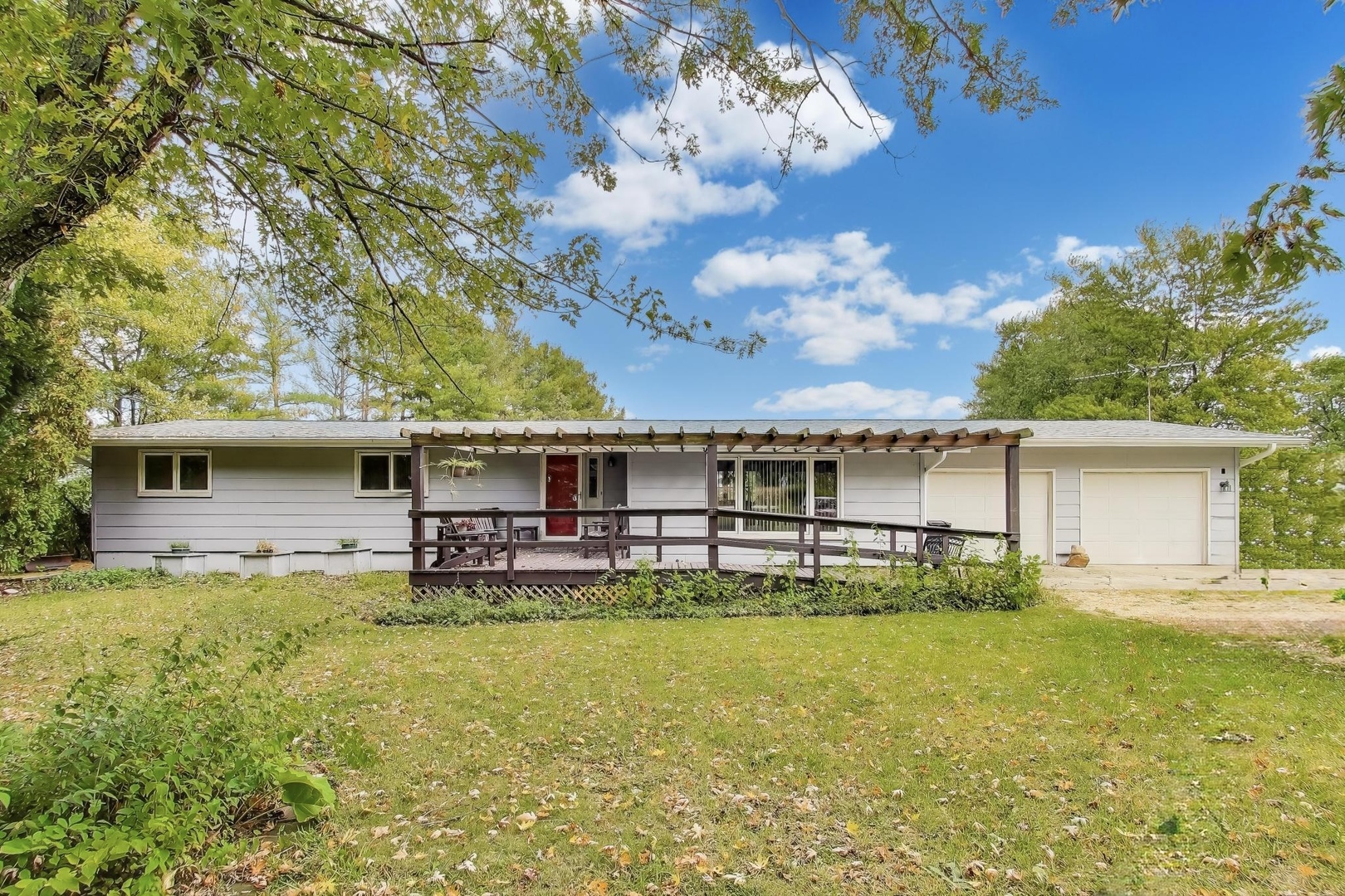 a view of a house with pool and chairs