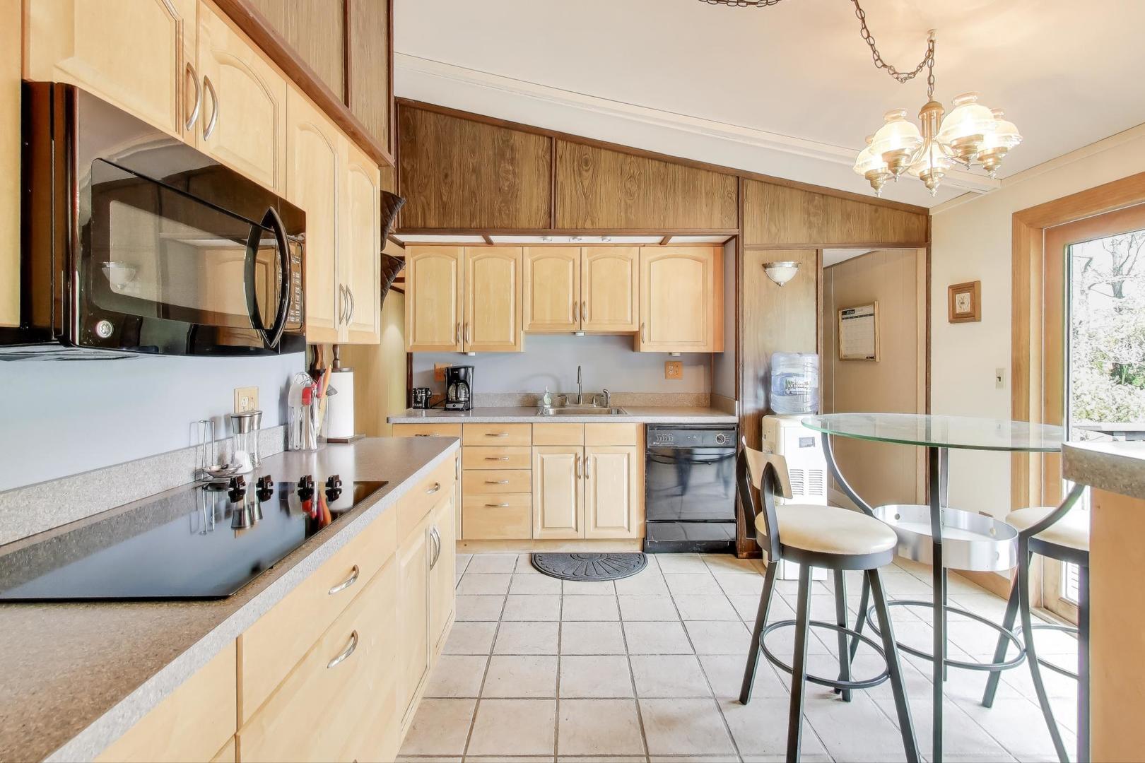 27809 South Will Center Road Monee, IL 60449 - Photo 12 of 47 a kitchen with a dining table chairs and a sink