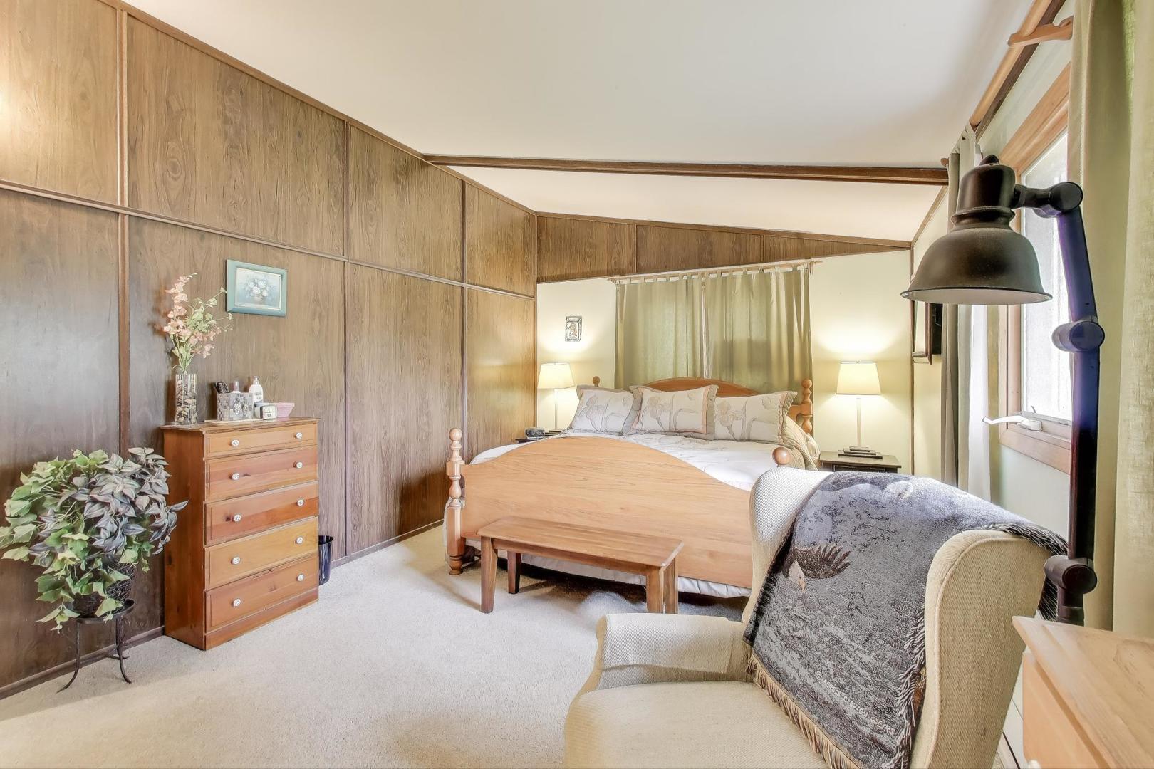 27809 South Will Center Road Monee, IL 60449 - Photo 17 of 47 a spacious bedroom with a bed and a chandelier
