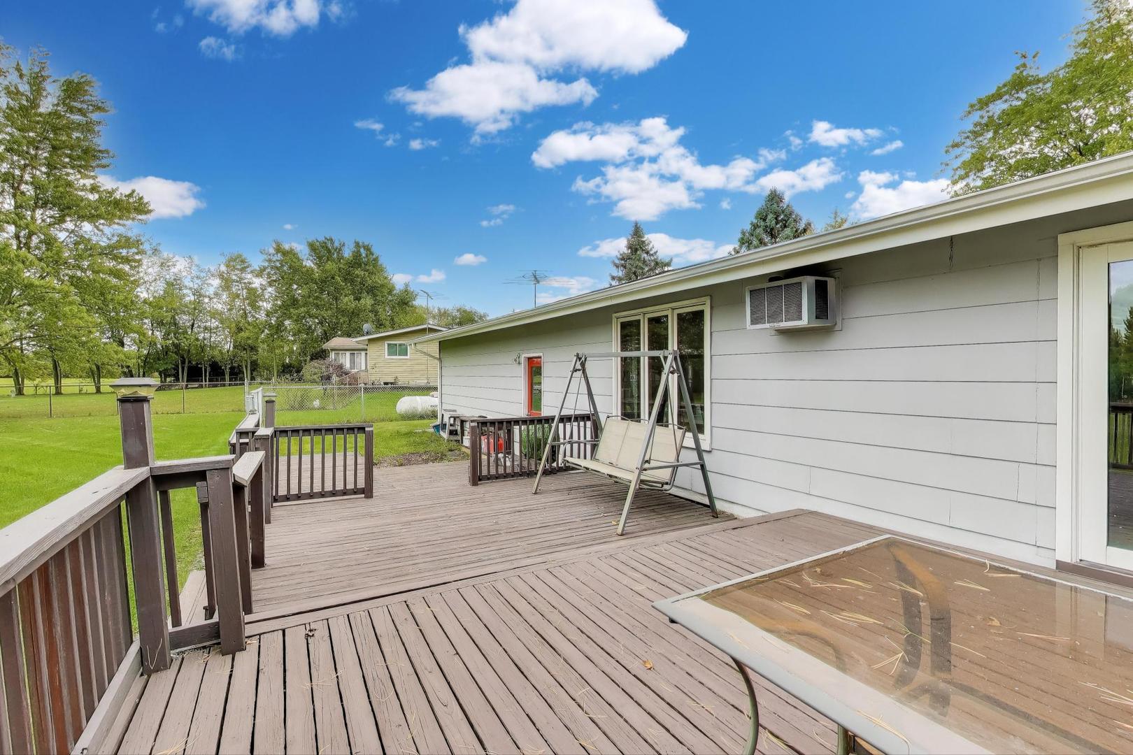 27809 South Will Center Road Monee, IL 60449 - Photo 34 of 47 a roof deck with table and chairs and wooden floor