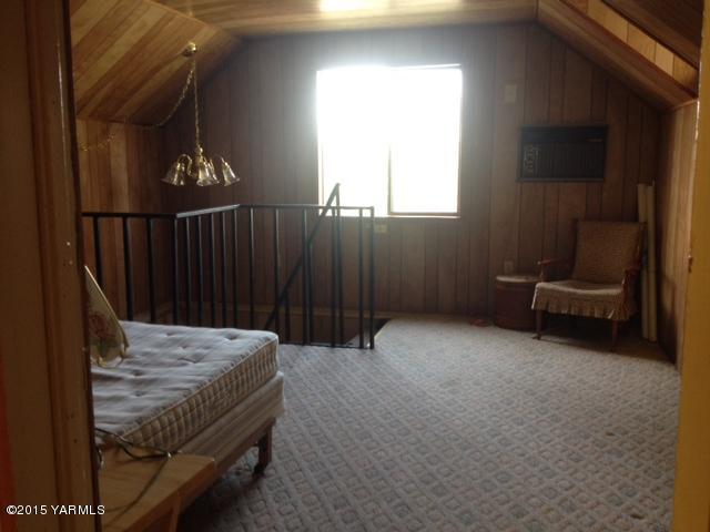 2490 Ashue Road Wapato, WA 98951 - Photo 10 of 11 a bed sitting in a room next to a window