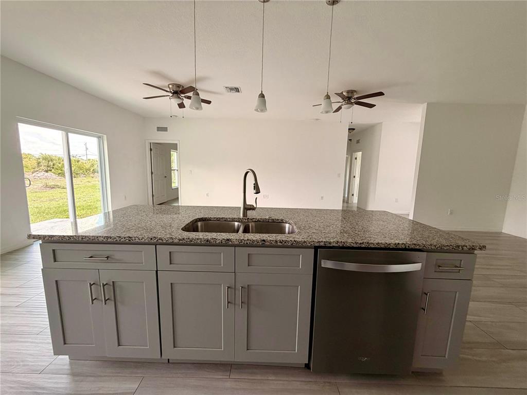 14142 Appleton Boulevard Port Charlotte, FL 33981 - Photo 6 of 26 a kitchen with a sink and a window