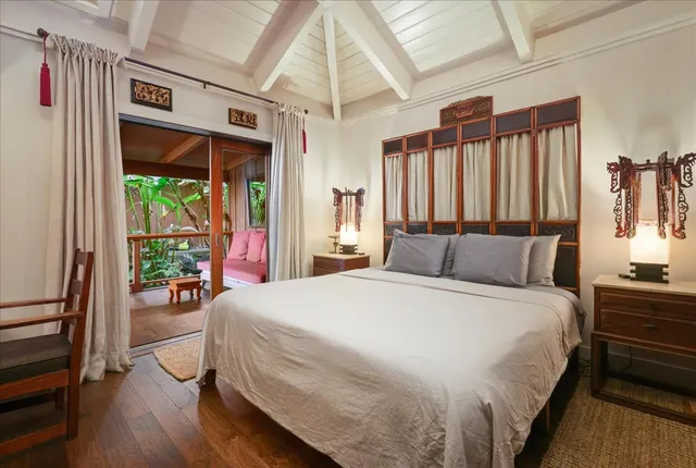 a spacious bedroom with a large bed and a large window