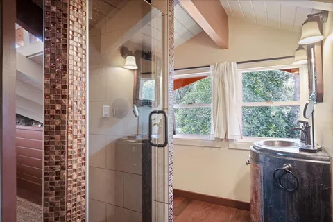 a bathroom with a granite countertop sink and a window