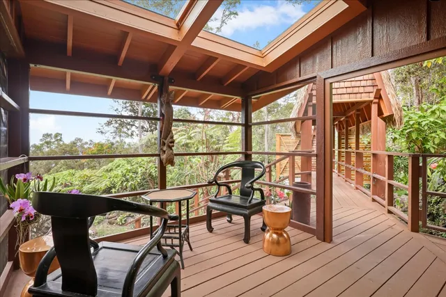 a view of a chairs and table in the balcony