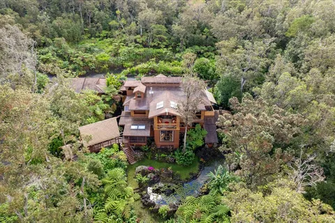 an aerial view of a house with a yard