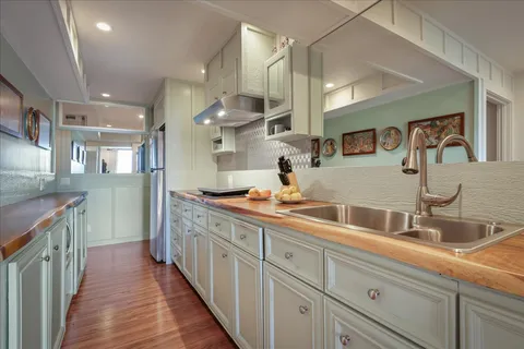 a spacious bathroom with a double vanity sink and a mirror