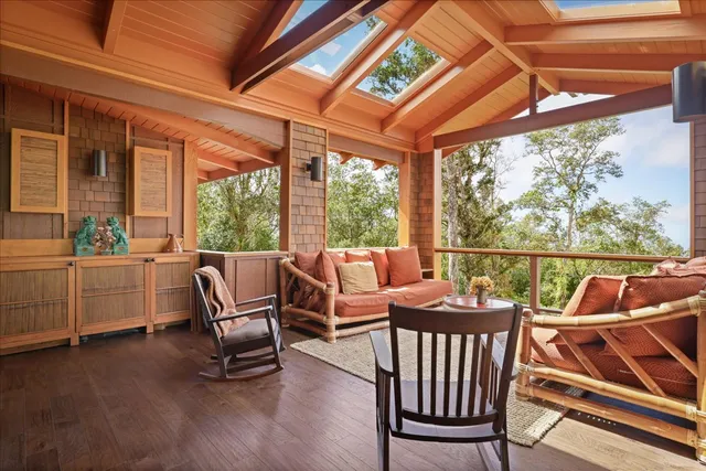 a balcony with furniture and wooden floor