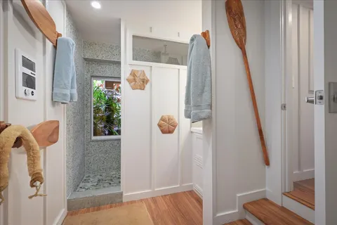 a view of walk in closet with clothes and plants