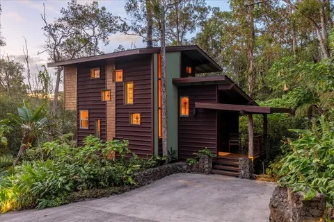 a front view of a house with garden