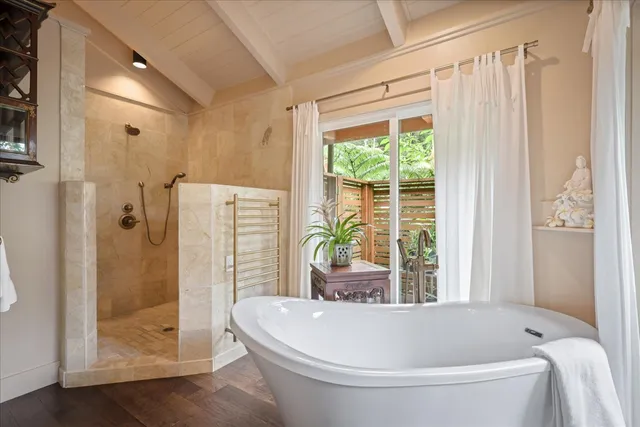 a white bath tub sitting next to a white toilet