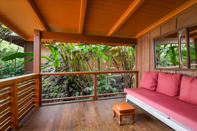 a roof deck with couch and wooden floor