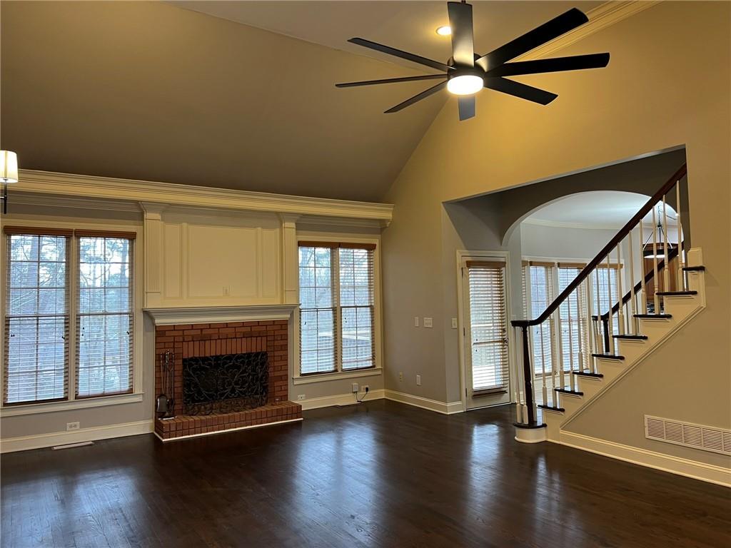 2476 Sewell Mill Road Marietta, GA 30062 - Photo 11 of 43 a view of an empty room with wooden floor fireplace and a window