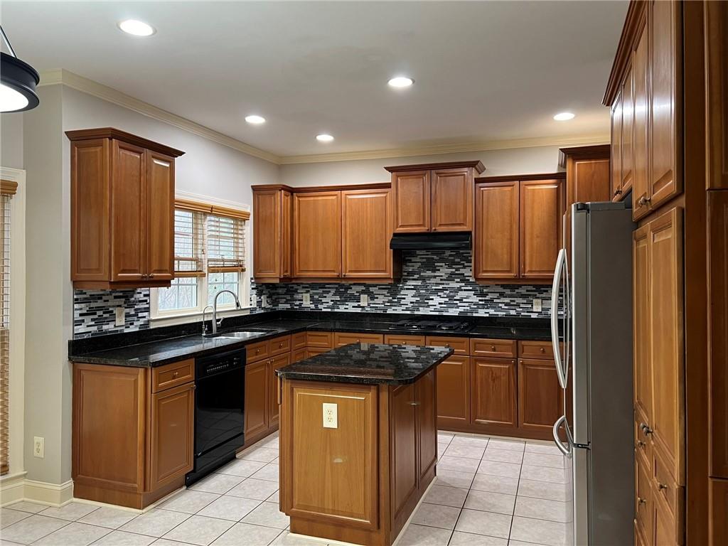 2476 Sewell Mill Road Marietta, GA 30062 - Photo 15 of 43 a kitchen with stainless steel appliances granite countertop a sink stove and refrigerator