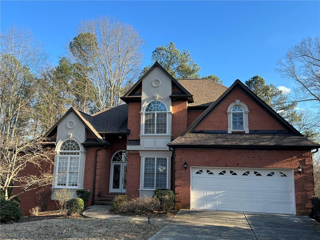 2476 Sewell Mill Road Marietta, GA 30062 - Photo 2 of 43 a front view of a house with garden