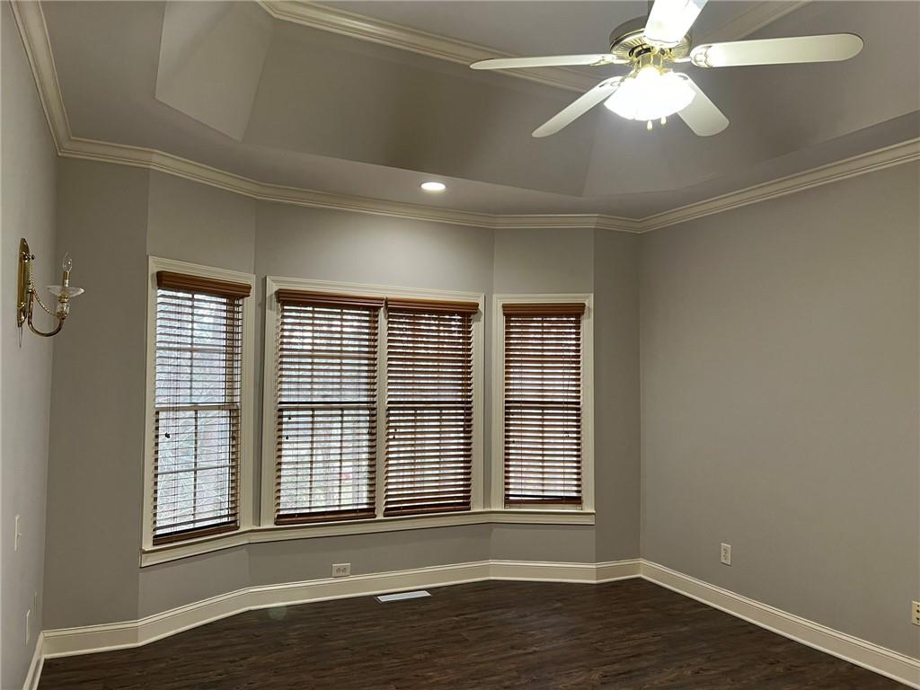 2476 Sewell Mill Road Marietta, GA 30062 - Photo 21 of 43 an empty room with wooden floor fan and windows