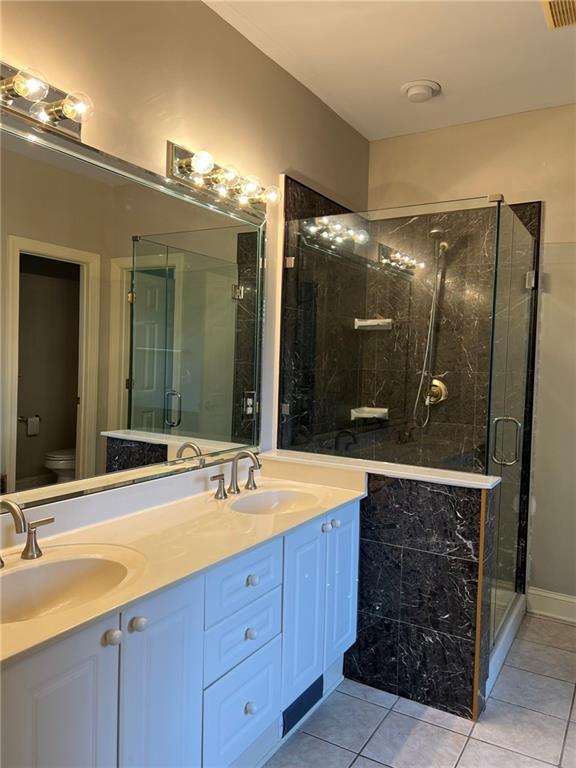 2476 Sewell Mill Road Marietta, GA 30062 - Photo 22 of 43 a bathroom with a sink double vanity and a mirror