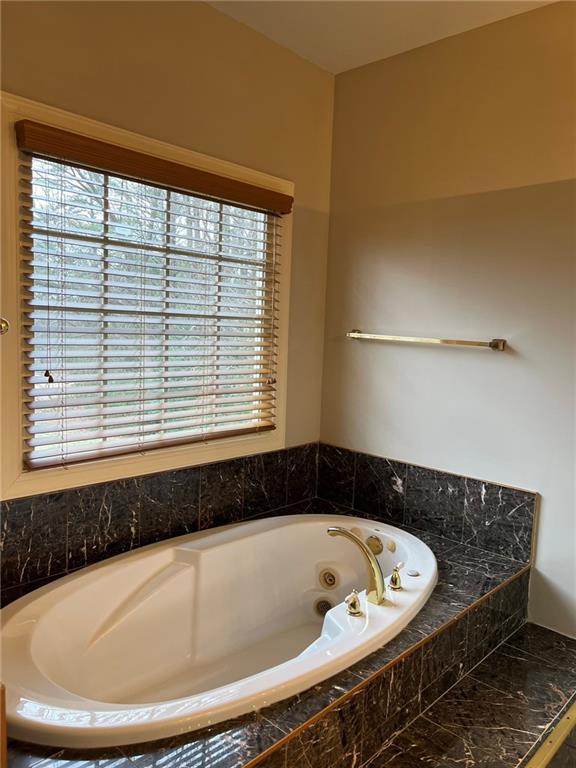 2476 Sewell Mill Road Marietta, GA 30062 - Photo 24 of 43 a bathroom with a bathtub and next to a window