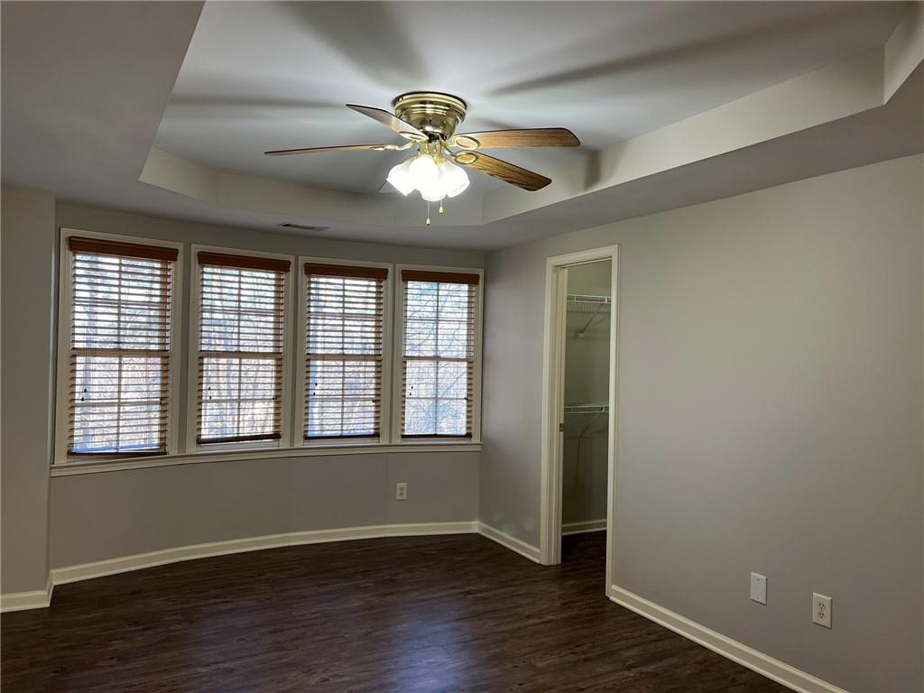 2476 Sewell Mill Road Marietta, GA 30062 - Photo 26 of 43 a view of an empty room with wooden floor and a window