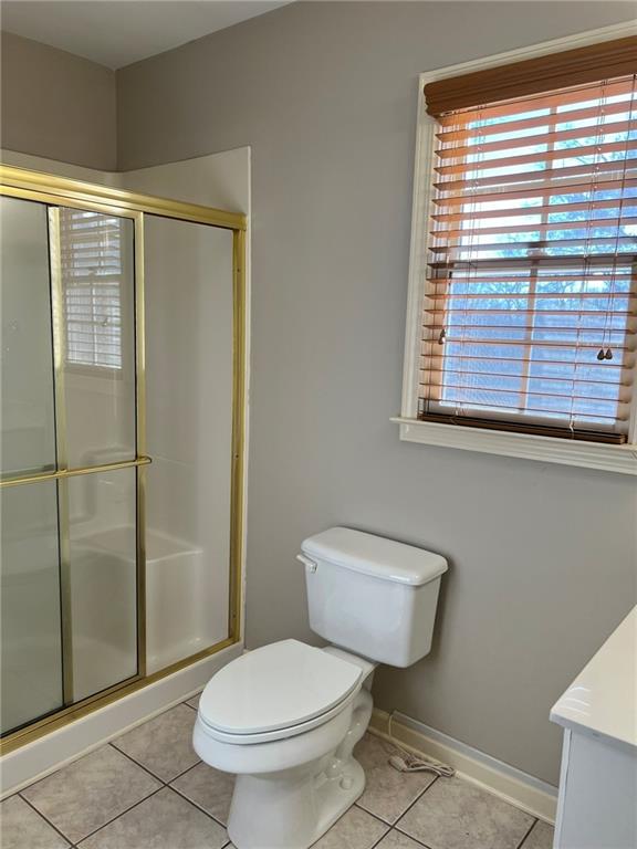 2476 Sewell Mill Road Marietta, GA 30062 - Photo 27 of 43 a white toilet sitting next to a bathroom and a shower