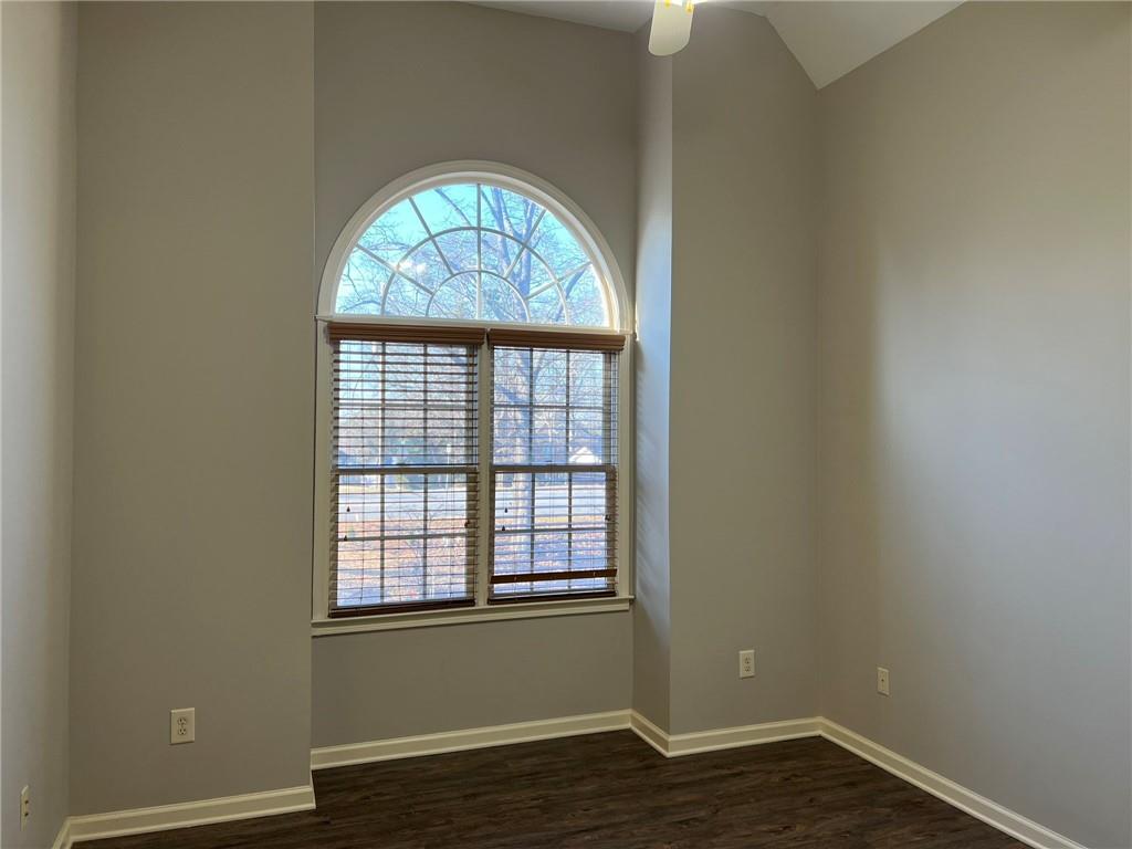 2476 Sewell Mill Road Marietta, GA 30062 - Photo 28 of 43 an empty room with wooden floor windows and outdoor view