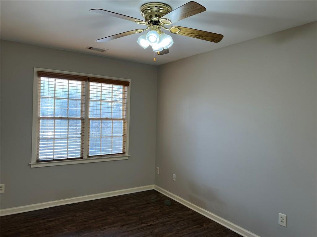 2476 Sewell Mill Road Marietta, GA 30062 - Photo 30 of 43 a view of an empty room with wooden floor and a window