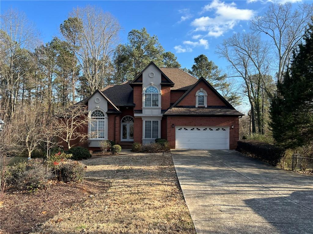 2476 Sewell Mill Road Marietta, GA 30062 - Photo 43 of 43 a front view of a house with a yard and garage