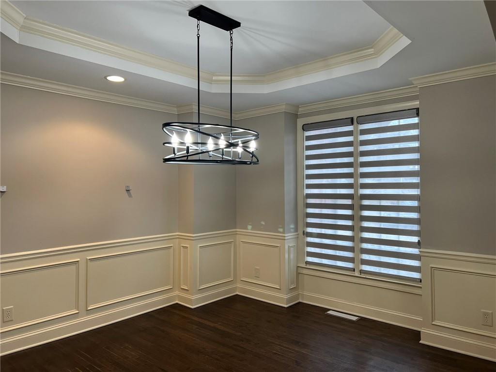 2476 Sewell Mill Road Marietta, GA 30062 - Photo 6 of 43 a view of an empty room with wooden floor and a window