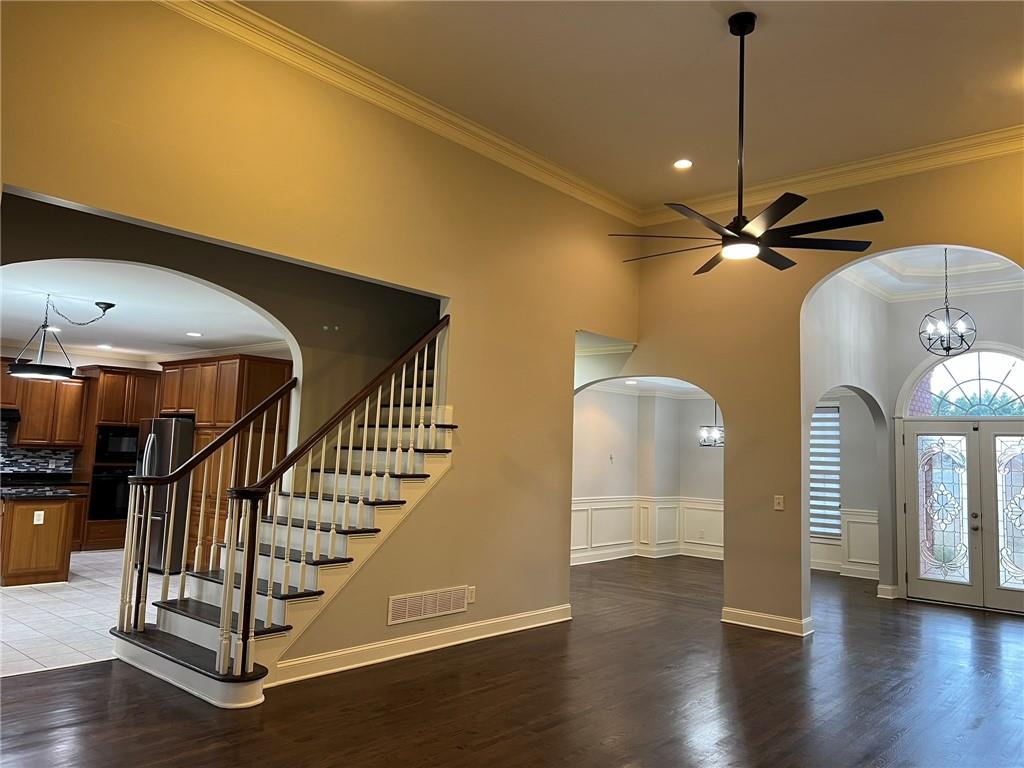 2476 Sewell Mill Road Marietta, GA 30062 - Photo 8 of 43 a view of a livingroom with wooden floor a ceiling fan and staircase