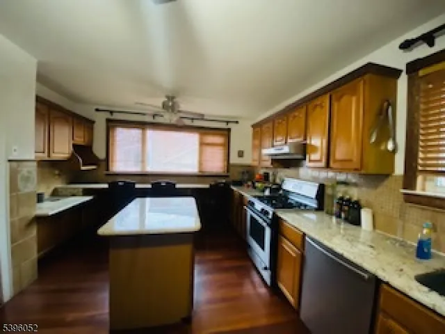 a kitchen with a stove a sink a microwave and cabinets