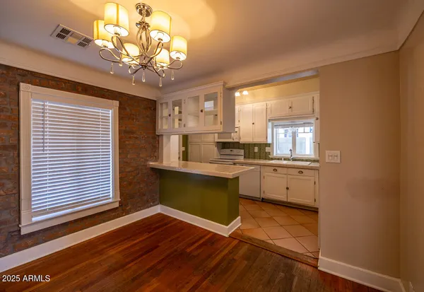 a kitchen with a refrigerator and windows