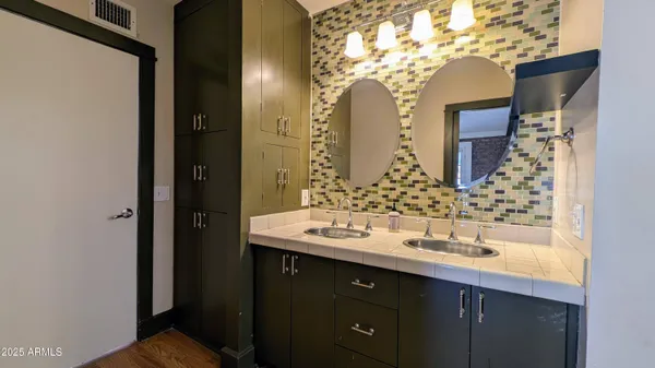 a bathroom with a double vanity sink and a mirror