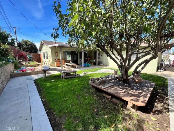 a front view of a house with garden and trees