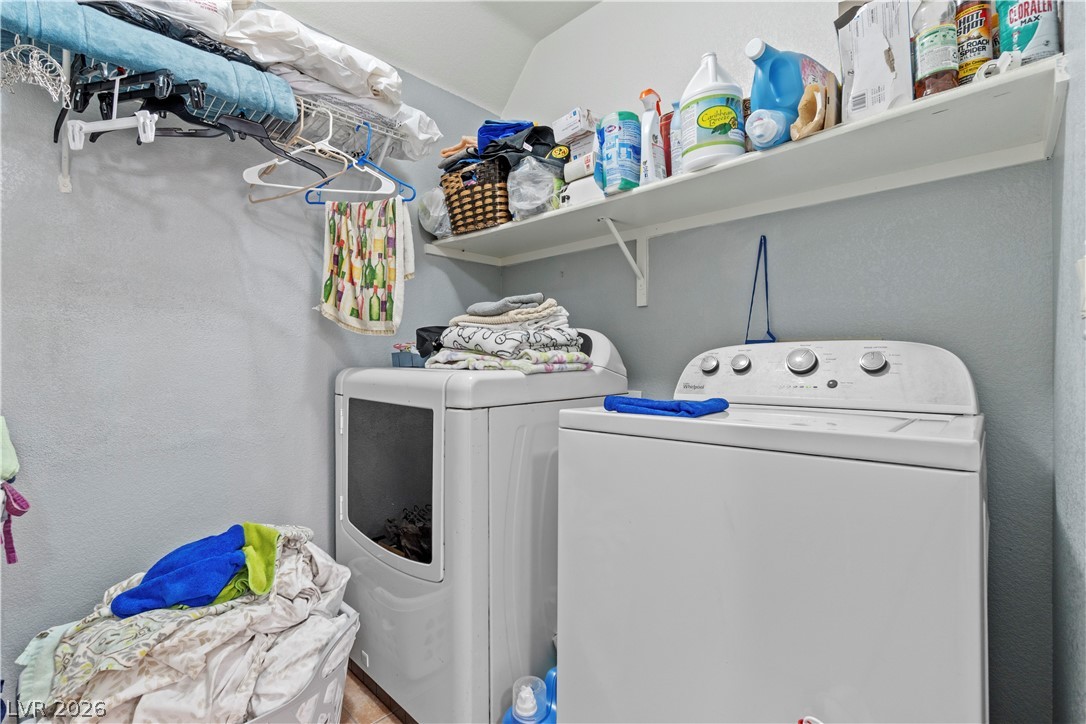 1419 Red Sunset Avenue Henderson, NV 89074 - Photo 31 of 35 Laundry room featuring washing machine and dryer and a textured wall