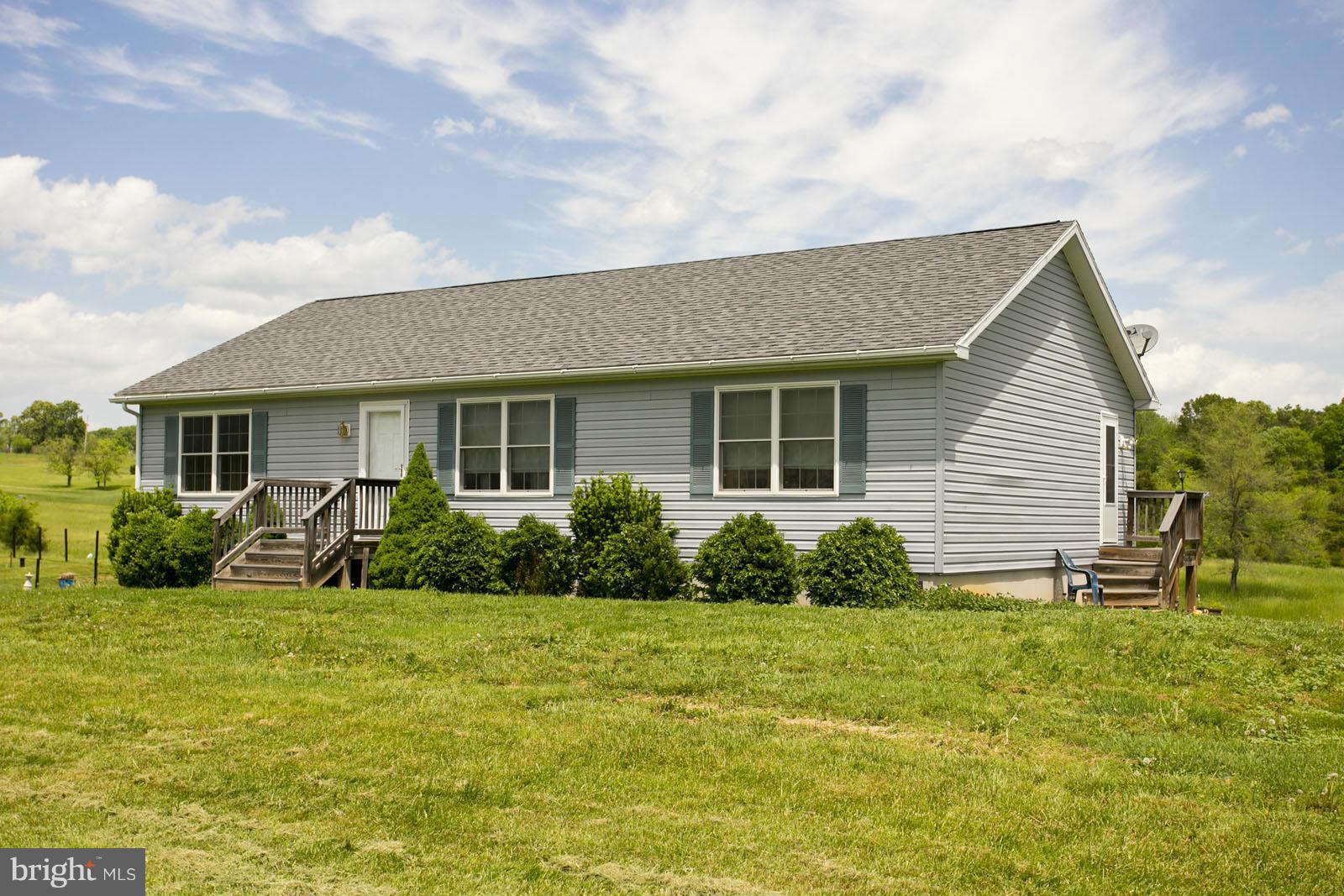 611 Veterans Road Middletown, VA 22645 - Photo 1 of 14 a front view of house with yard and green space