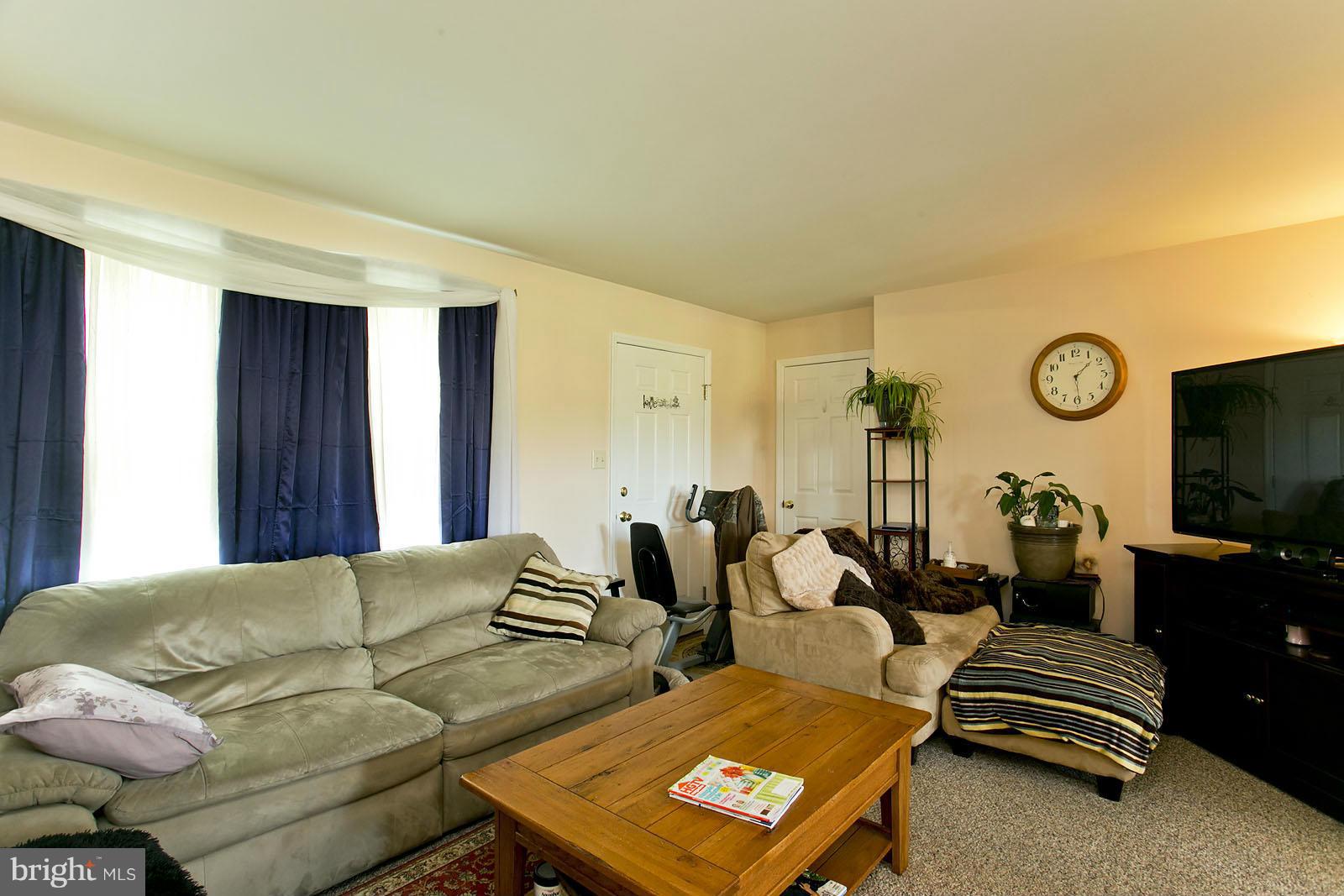 611 Veterans Road Middletown, VA 22645 - Photo 3 of 14 a living room with couches and a flat screen tv