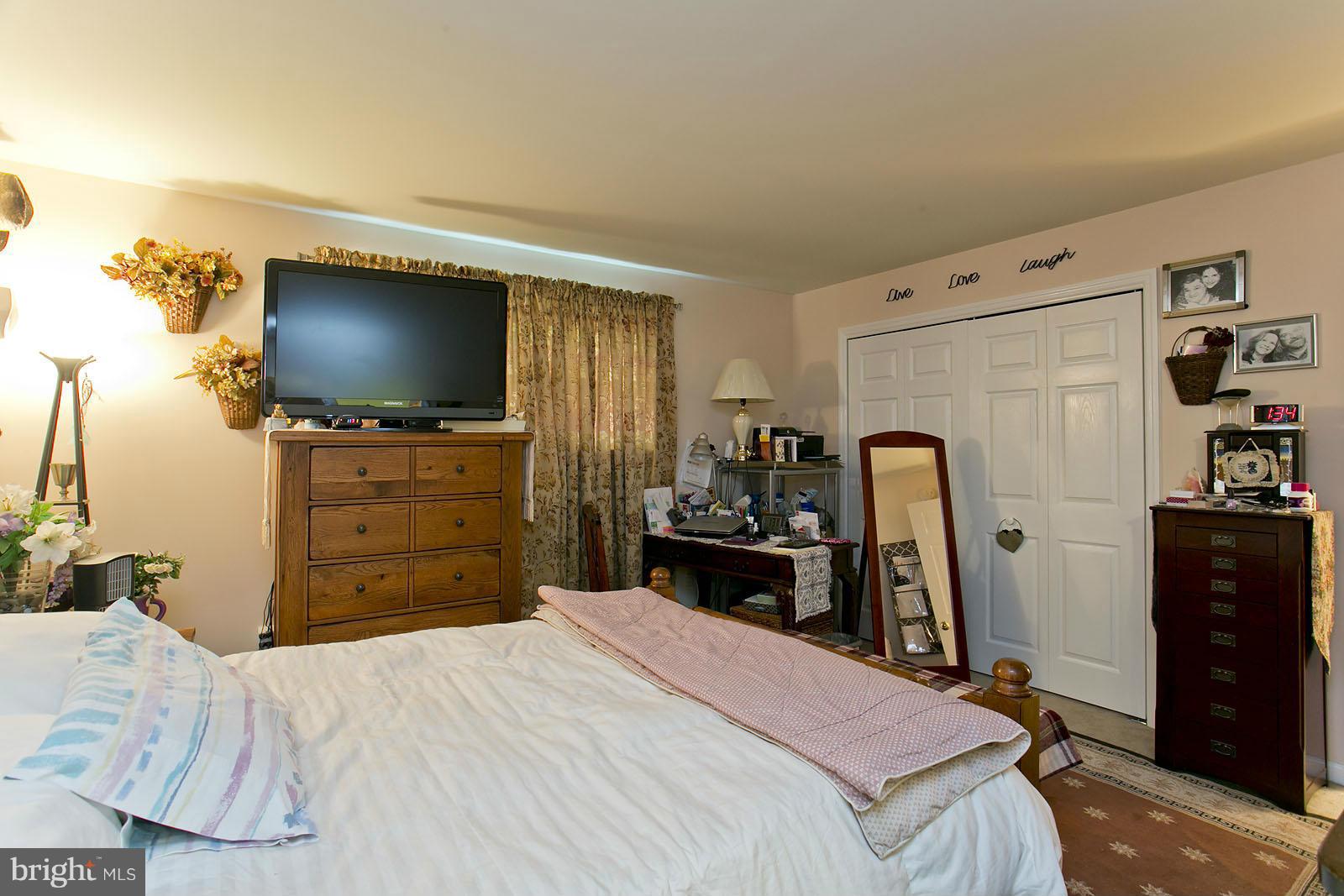 611 Veterans Road Middletown, VA 22645 - Photo 6 of 14 a bedroom with a bed and a flat screen tv