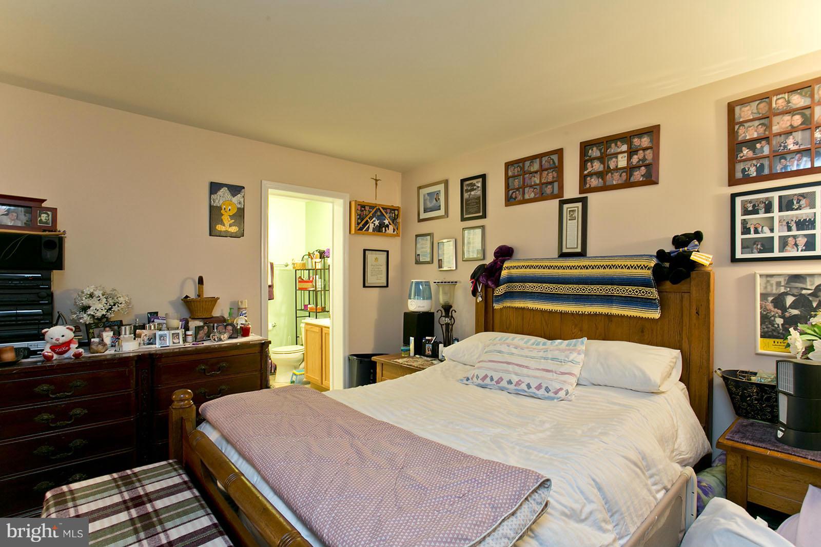 611 Veterans Road Middletown, VA 22645 - Photo 7 of 14 a bedroom with a bed and dresser