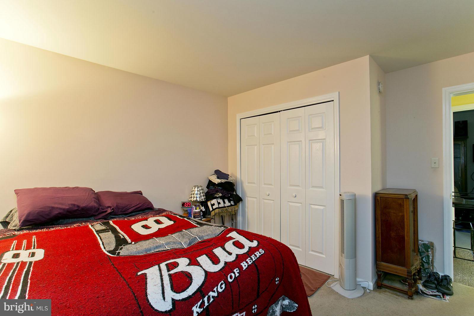 611 Veterans Road Middletown, VA 22645 - Photo 10 of 14 a bedroom with a bed and a dresser in it