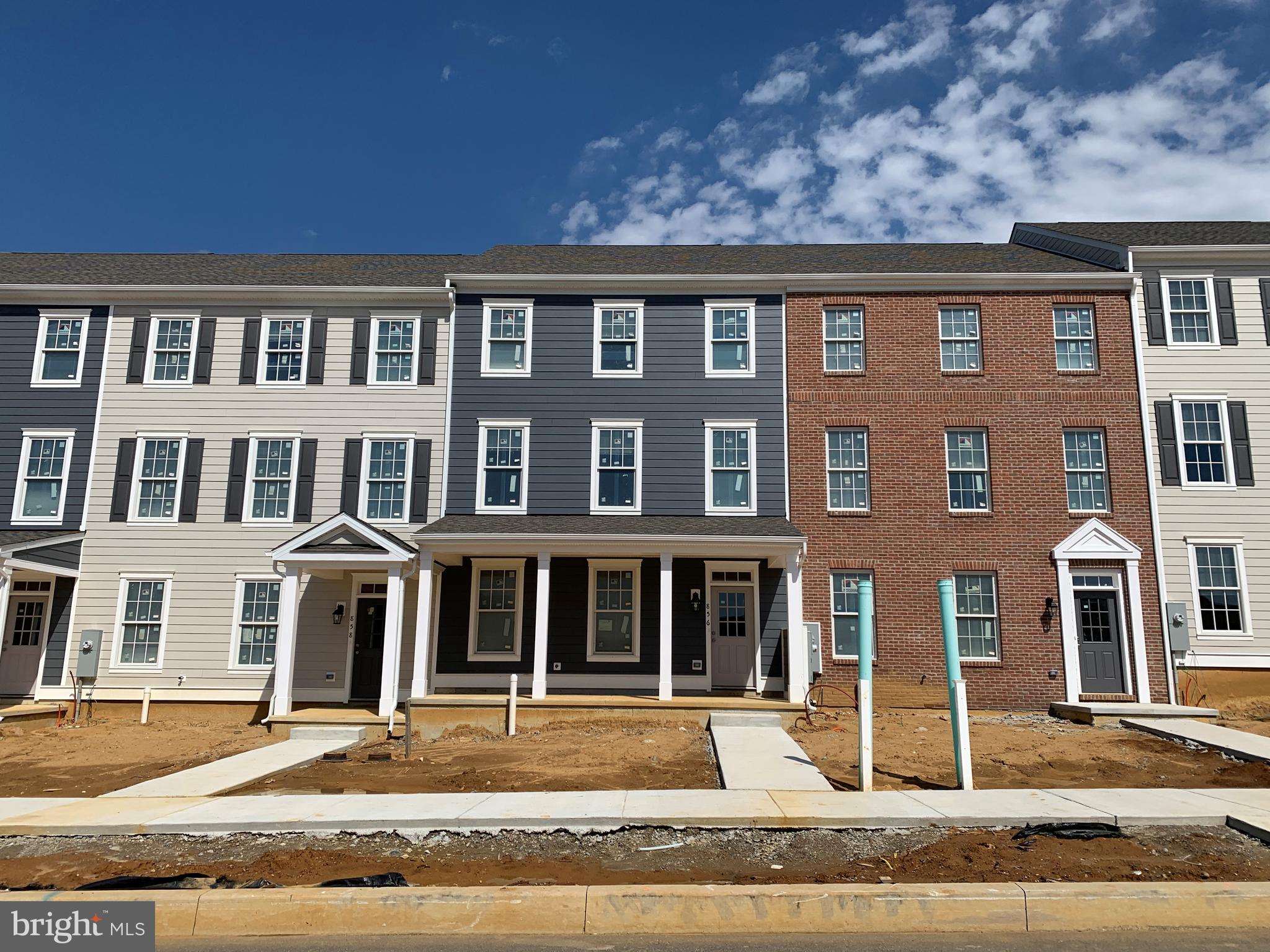 a front view of a building with a garden