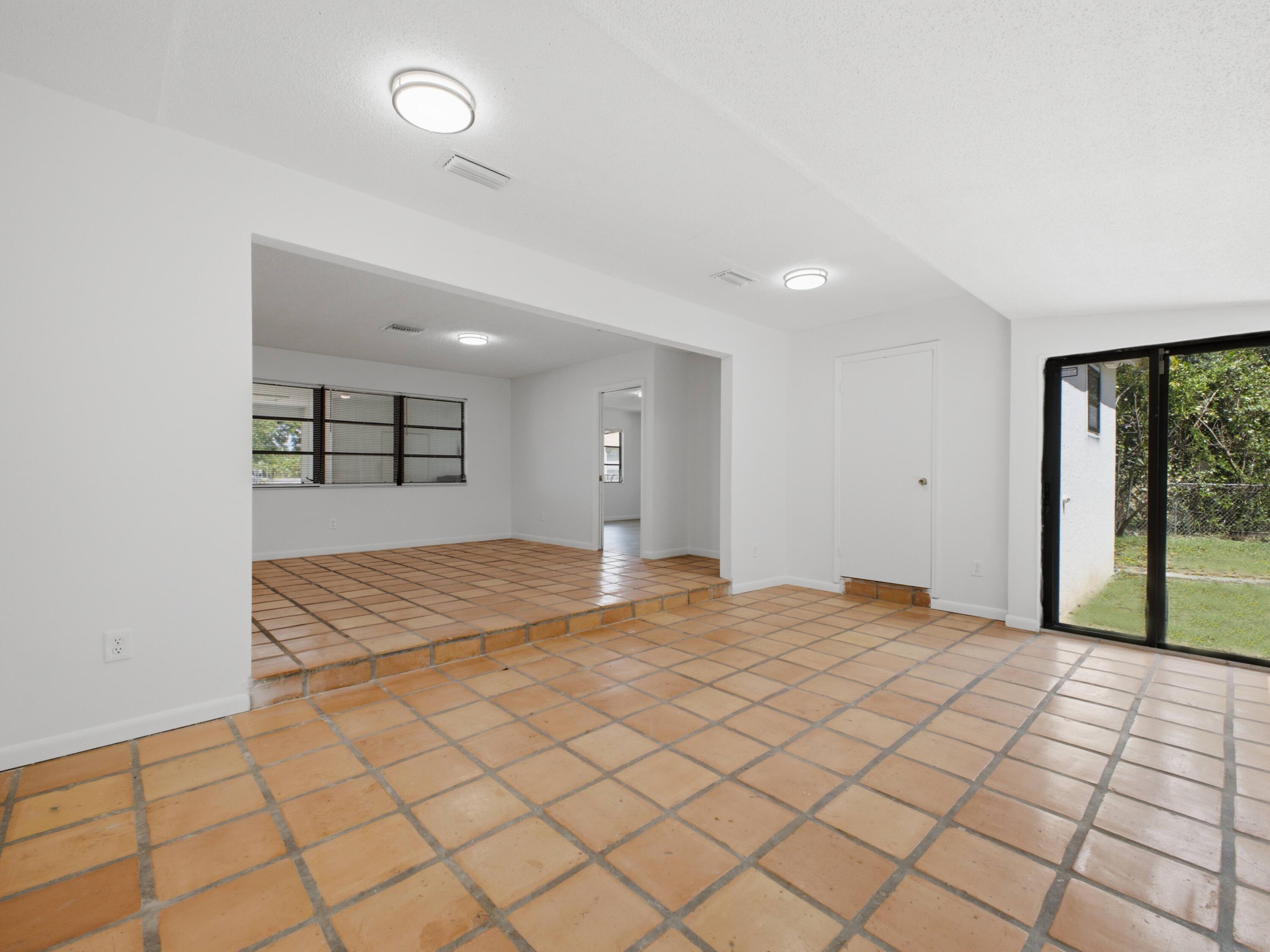 6700 Forest Court West Palm Beach, FL 33405 - Photo 20 of 45 Family to Dining Primary Bedroom