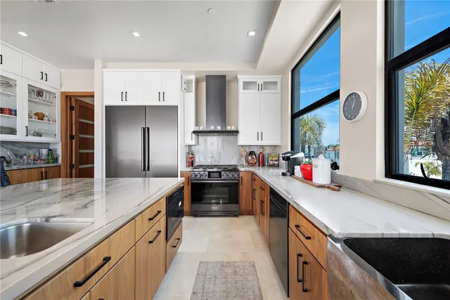 a kitchen with stainless steel appliances granite countertop a sink stove and refrigerator