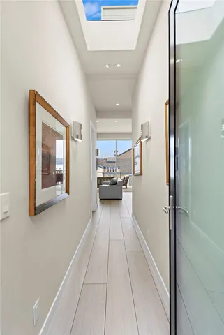 a view of a hallway with wooden floor and furniture