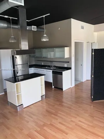 a kitchen with stainless steel appliances a refrigerator and a stove